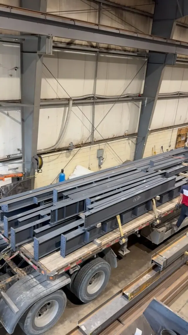 Fabricated steel loaded on a trailer inside the shop